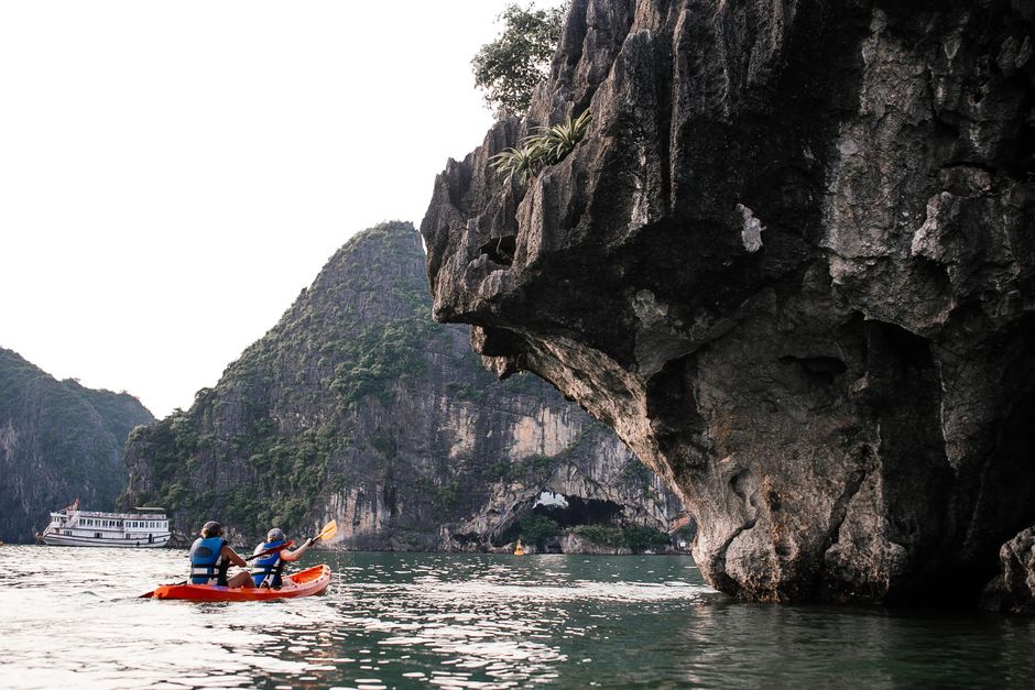 Mljet island Croatia sea cave entrance kayak paddler dark water limestone cliffs