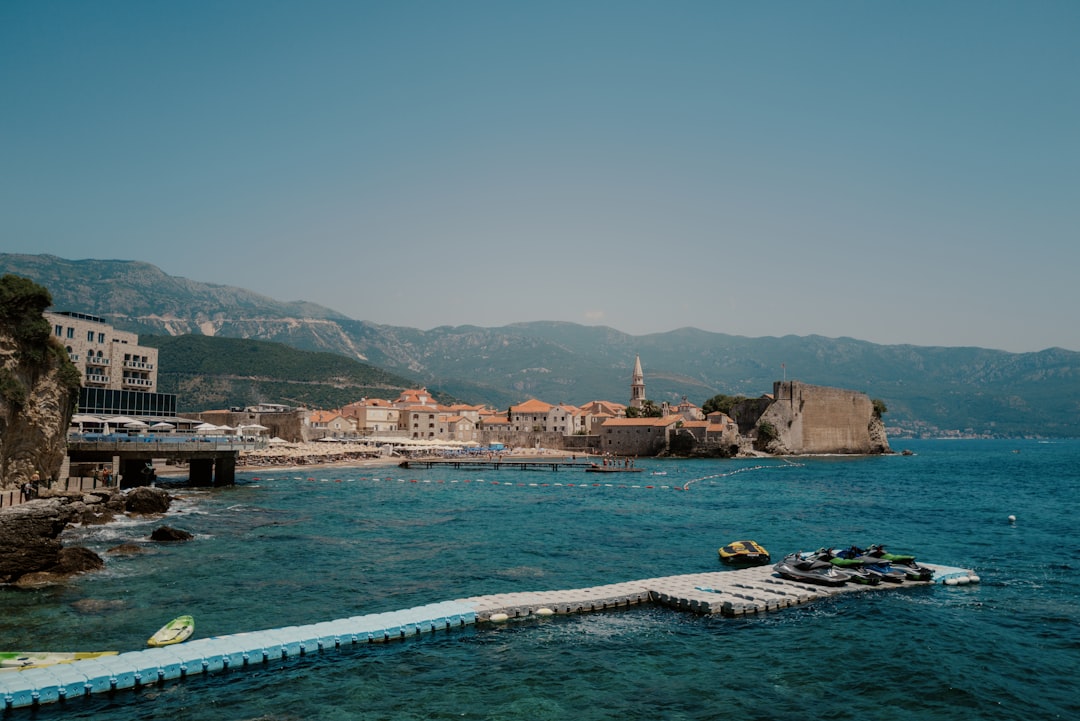 Mogren Beach Montenegro pebble beach turquoise water cliffs morning