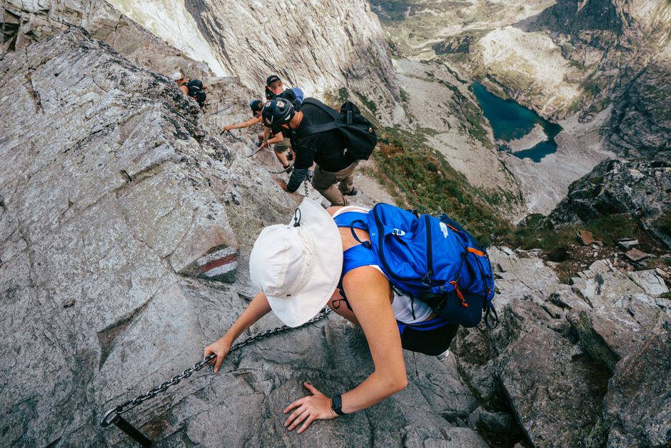 Hikers ascending rocky trail to Bobotov Kuk summit view