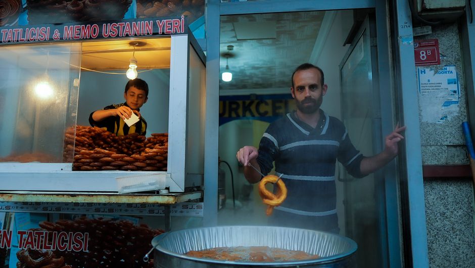 Prizren street food vendor selling burek pastry customers line up